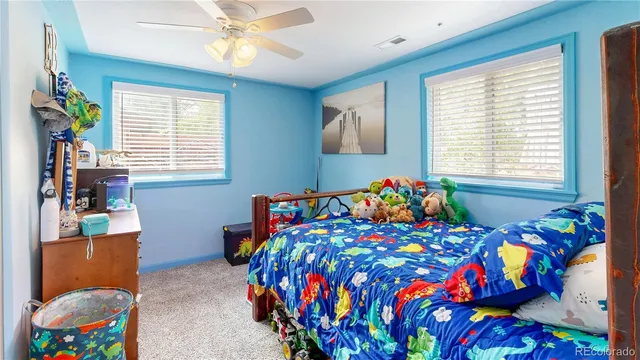 a bedroom with a bed and a painting on the wall