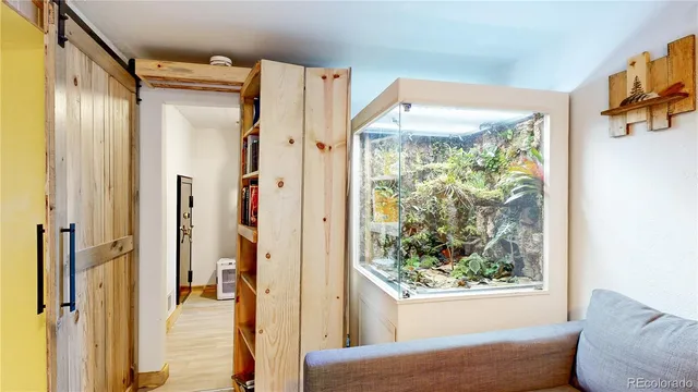 a view of a bedroom with wooden floor and a window