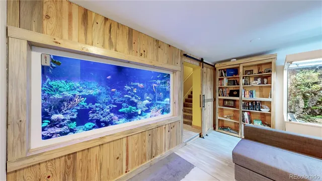 a living room with furniture and a bookshelf