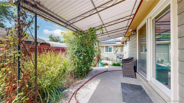 a view of a house with a small porch and furniture