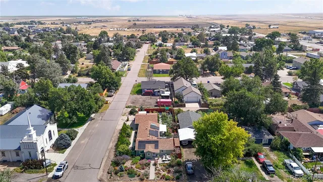 an aerial view of a city with lots of residential buildings ocean and mountain view in back