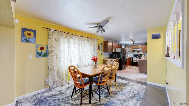 a view of a dining room with furniture and a chandelier
