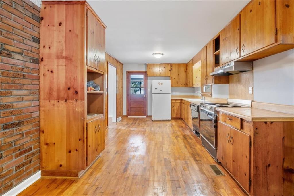 14 Mitchell Circle Southeast Rome, GA 30161 - Photo 14 of 39 a kitchen with stainless steel appliances granite countertop a refrigerator and a stove top oven
