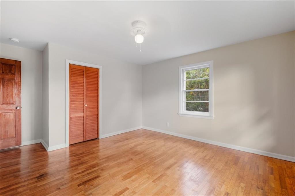 14 Mitchell Circle Southeast Rome, GA 30161 - Photo 16 of 39 an empty room with wooden floor and windows