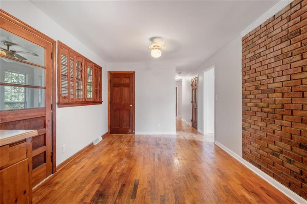 14 Mitchell Circle Southeast Rome, GA 30161 - Photo 25 of 39 a view of an empty room with wooden floor and a kitchen