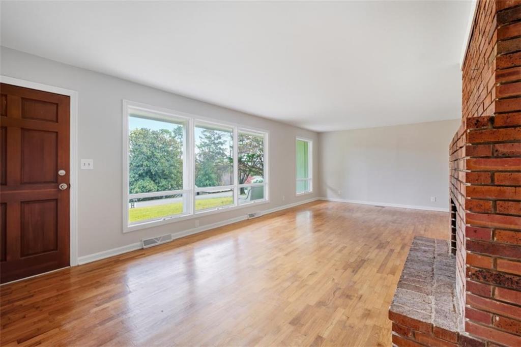 14 Mitchell Circle Southeast Rome, GA 30161 - Photo 29 of 39 a view of an empty room with wooden floor and a window