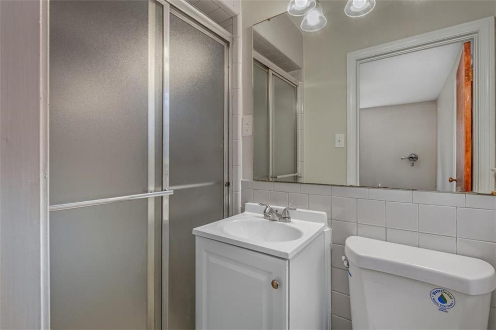 14 Mitchell Circle Southeast Rome, GA 30161 - Photo 33 of 39 a bathroom with a sink and mirror with toilet