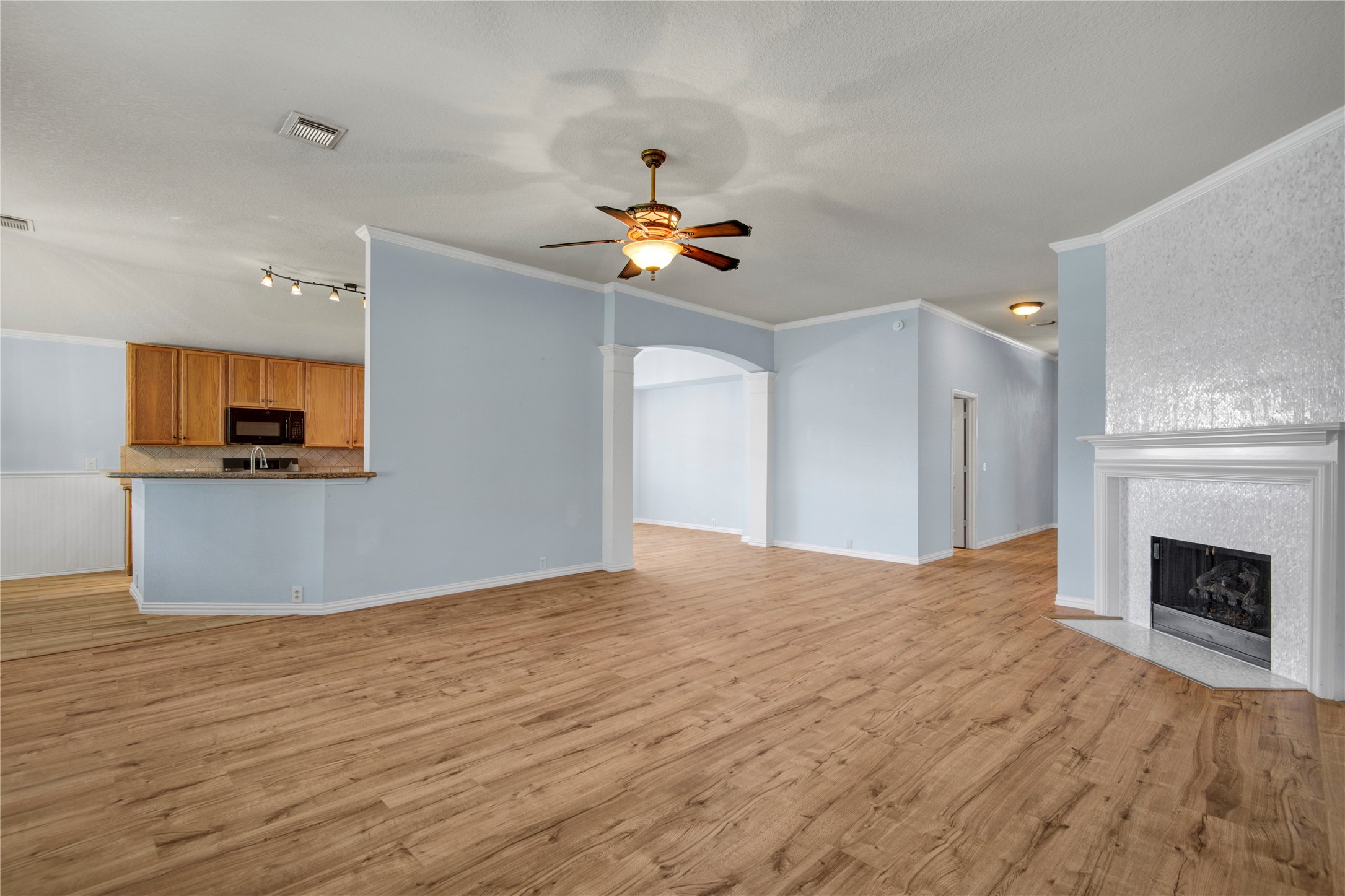 2206 Louetta Brook Lane Spring, TX 77388 - Photo 17 of 39 a view of an empty room with a fireplace and wooden floor
