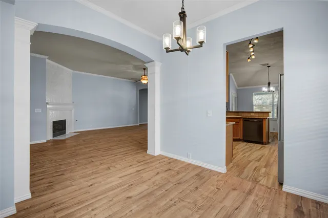 a view of a kitchen with a sink and an empty room