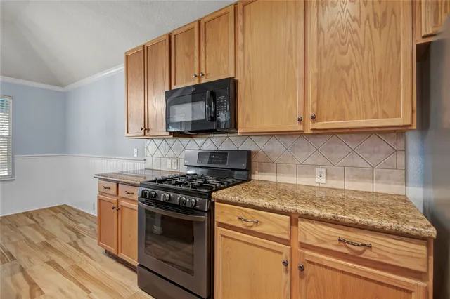 a kitchen with granite countertop cabinets stainless steel appliances and a sink