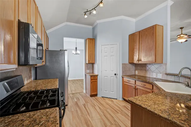 a kitchen with a refrigerator stove and sink