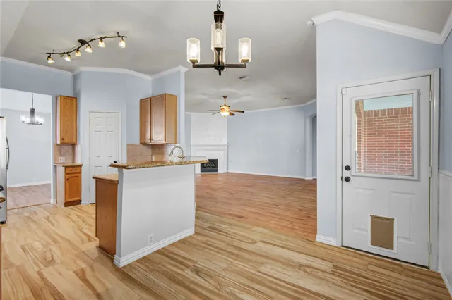 a room view with wooden floor and ceiling fan