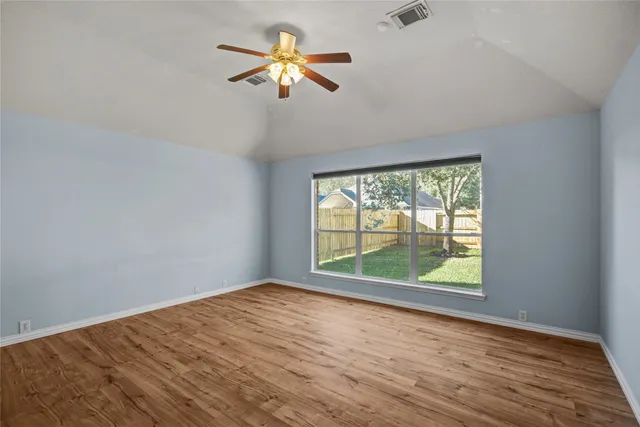 wooden floor in an empty room with a window