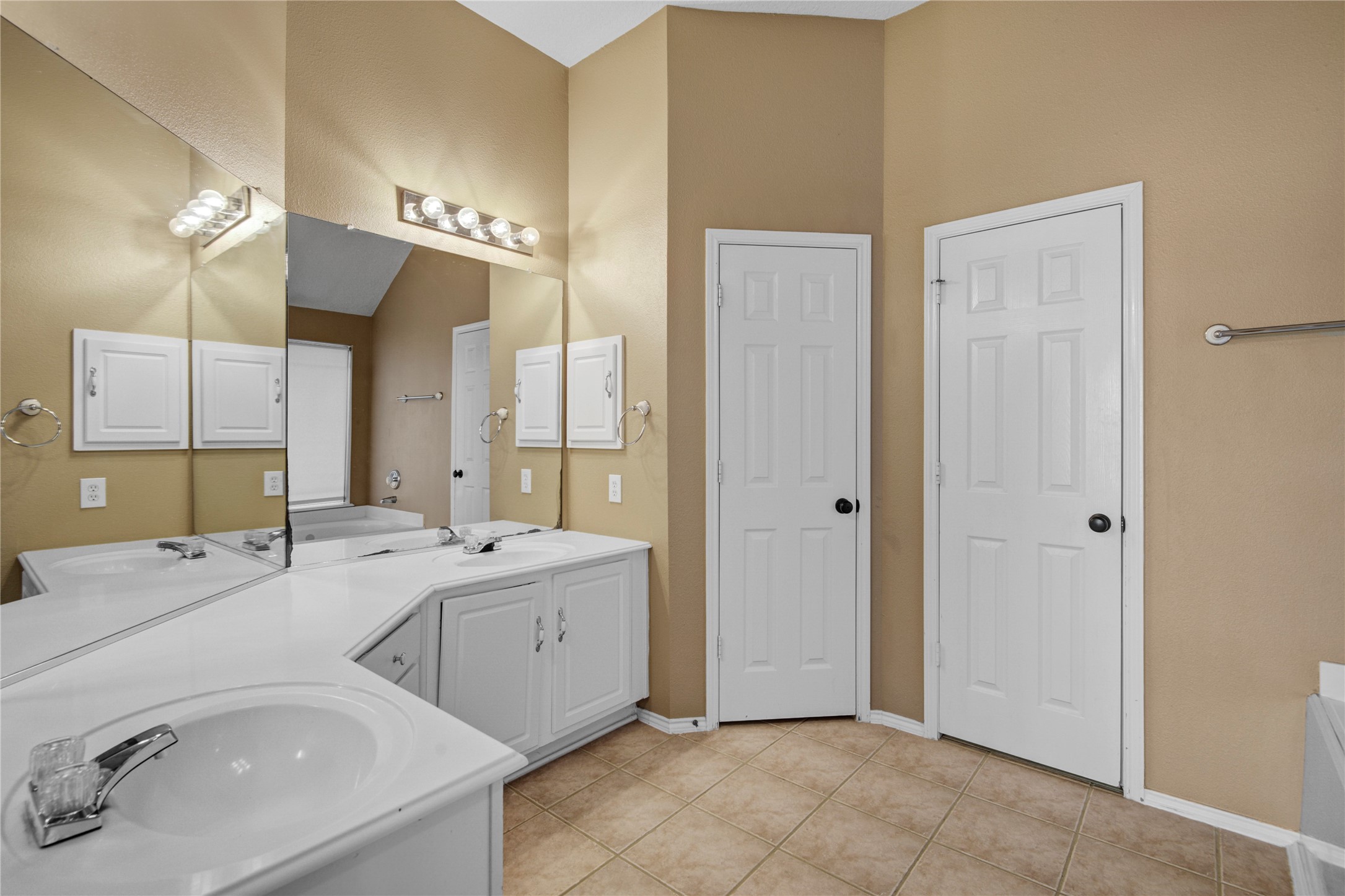 2206 Louetta Brook Lane Spring, TX 77388 - Photo 30 of 39 a spacious bathroom with a double vanity sink a mirror and a bathtub