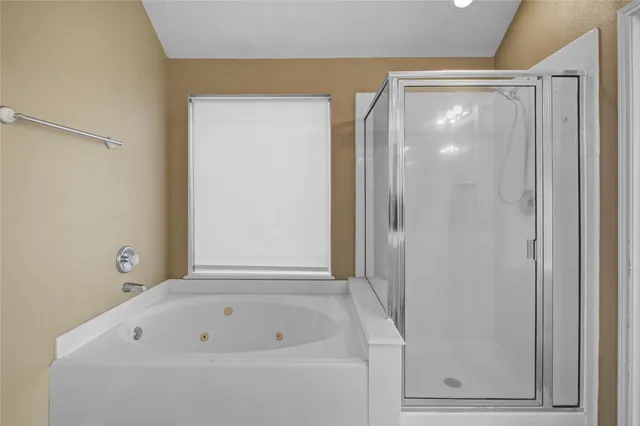 a bathroom with a bathtub and a shower