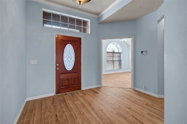 a view of an entryway with wooden floor
