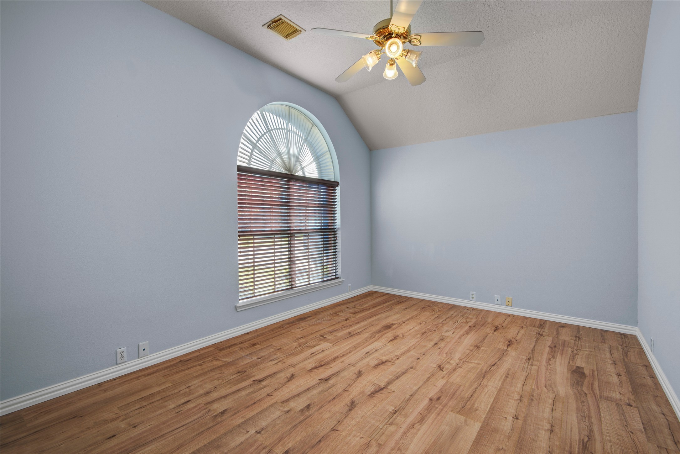 2206 Louetta Brook Lane Spring, TX 77388 - Photo 5 of 39 an empty room with wooden floor chandelier fan and windows
