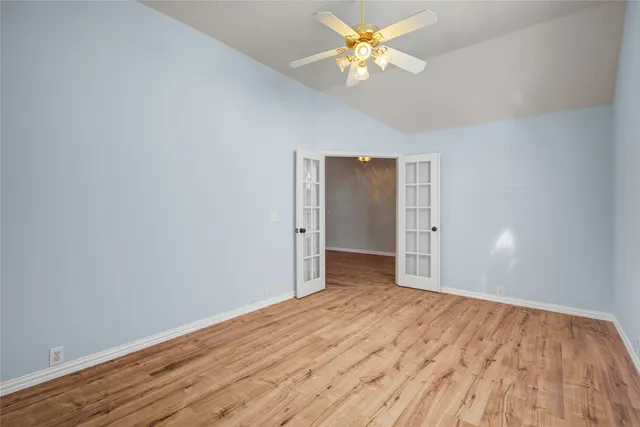 a view of empty room with wooden floor