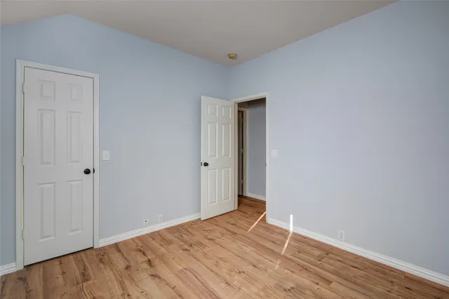 a view of a room with wooden floor and closet