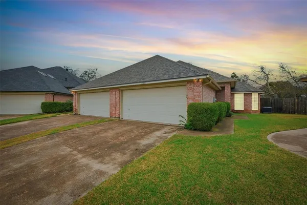 a view of a house with a yard and garage