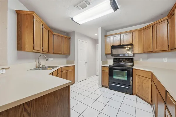 a kitchen with stainless steel appliances a stove sink and microwave