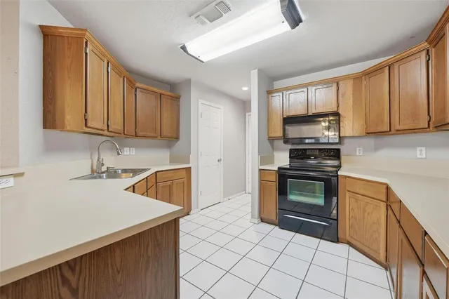 a kitchen with stainless steel appliances a stove sink and microwave