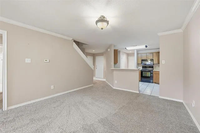 a view of a kitchen with refrigerator and white cabinets