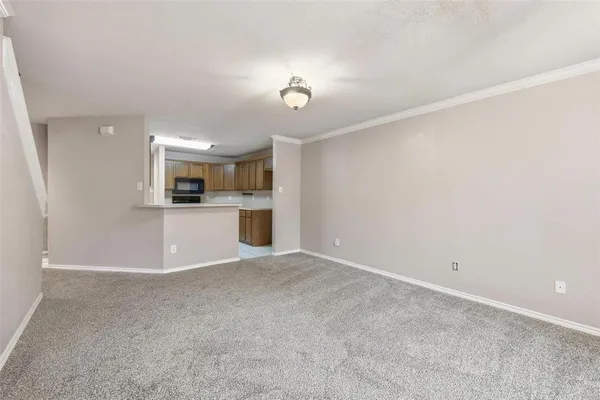 a view of a kitchen with a sink and a refrigerator