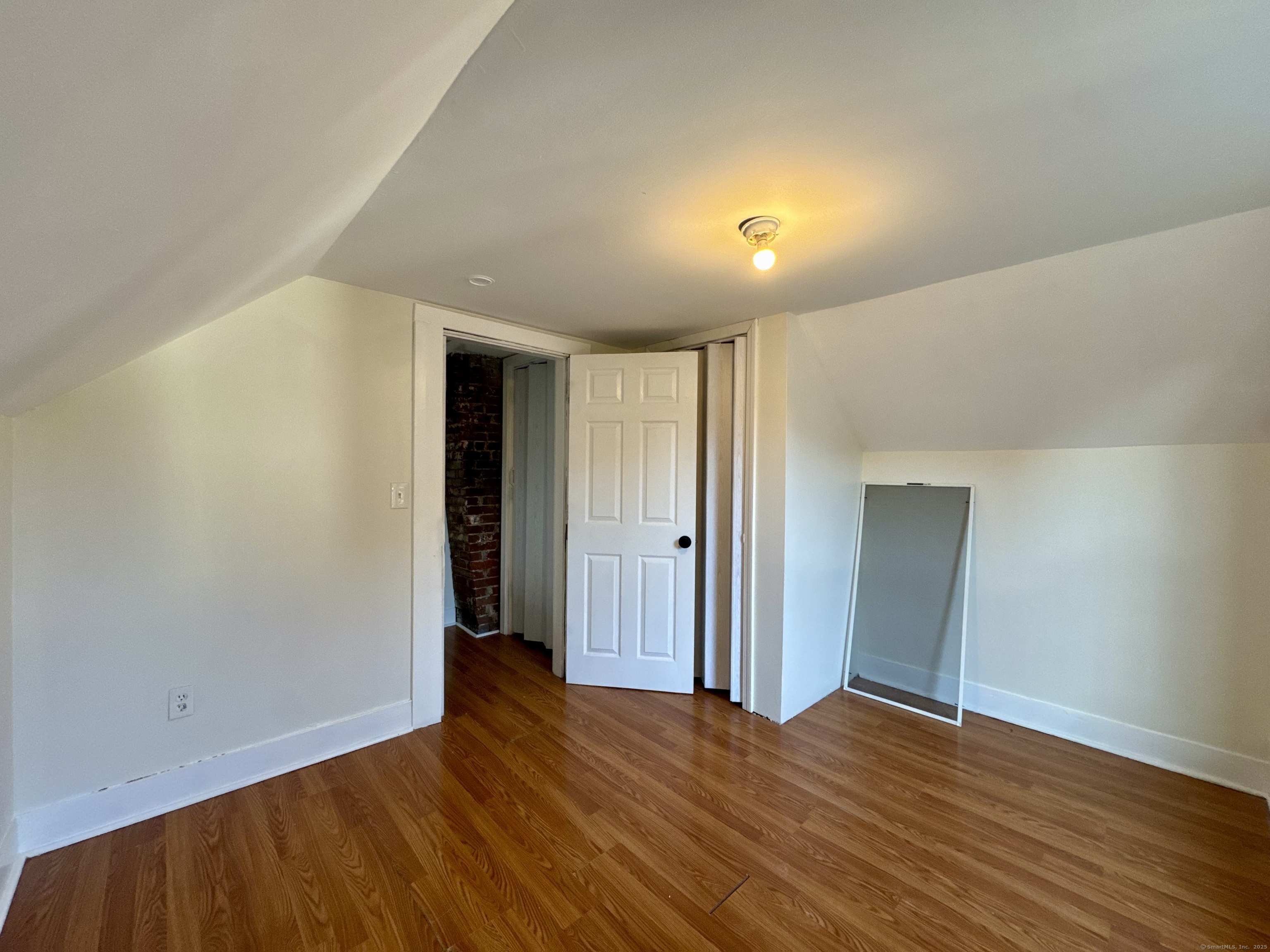 14 Culvert Street, Unit 2 Torrington, CT 06790 - Photo 11 of 17 a view of empty room with wooden floor