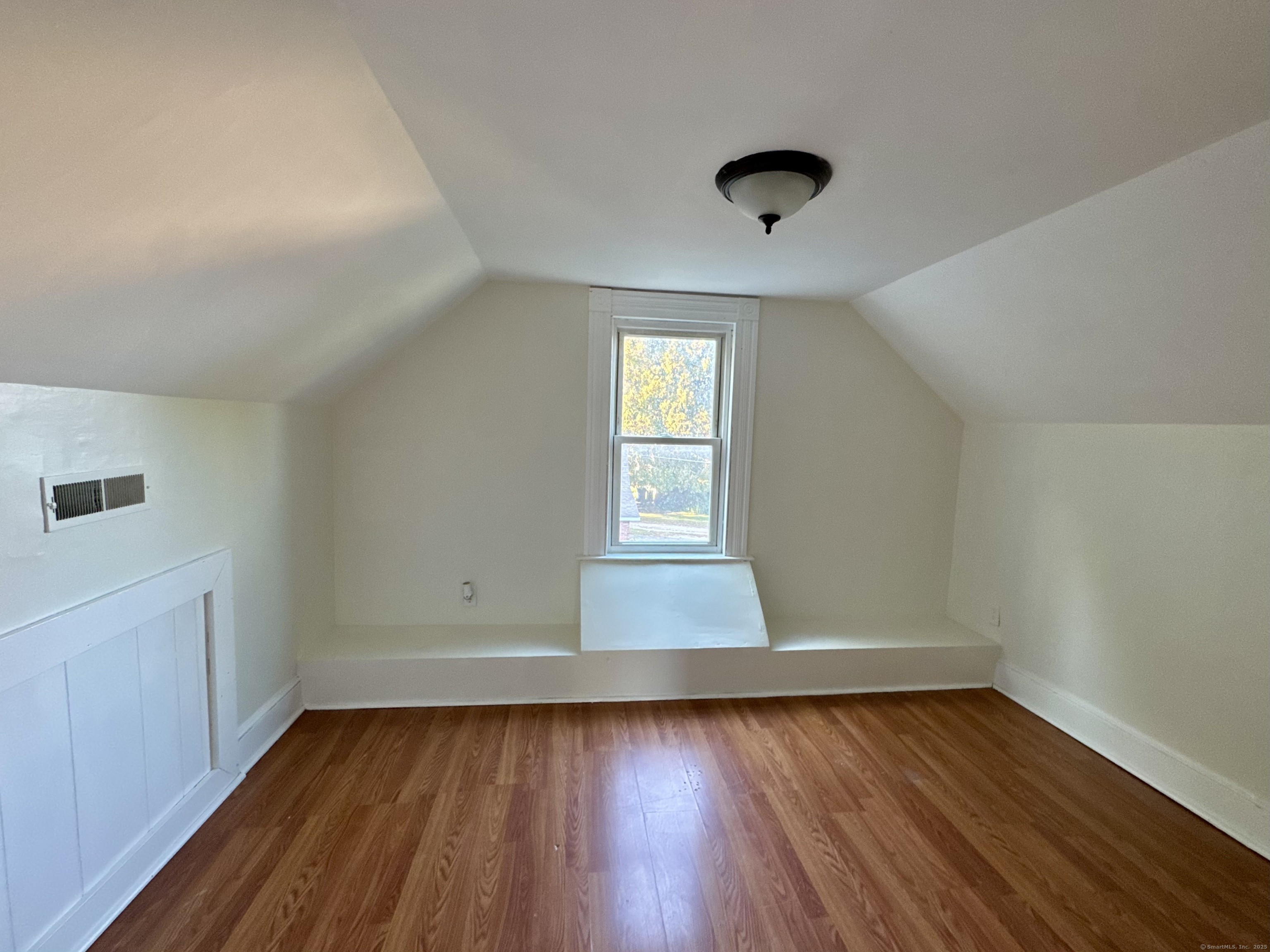 14 Culvert Street, Unit 2 Torrington, CT 06790 - Photo 12 of 17 an empty room with wooden floor and windows