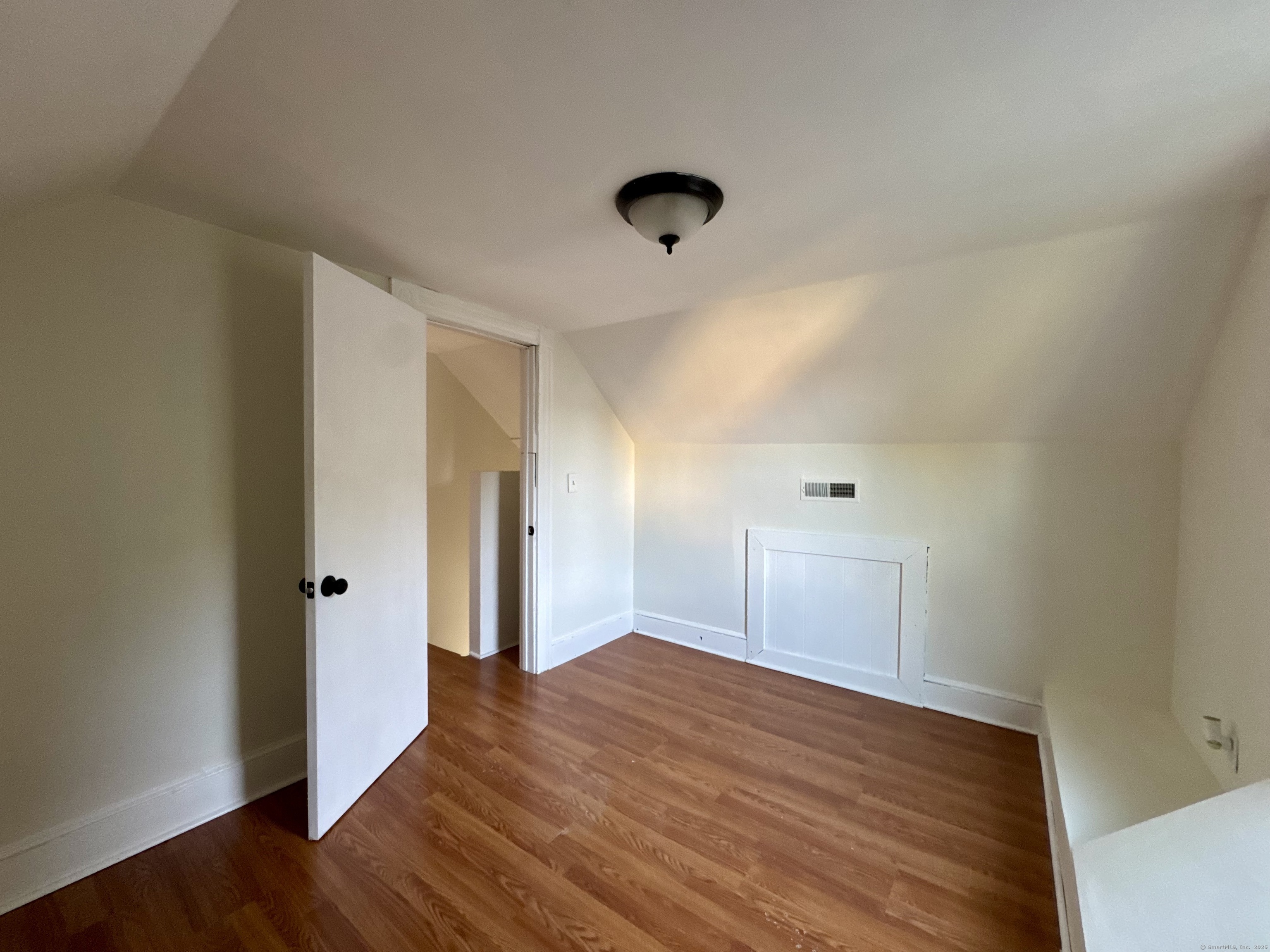 14 Culvert Street, Unit 2 Torrington, CT 06790 - Photo 14 of 17 a view of empty room with wooden floor