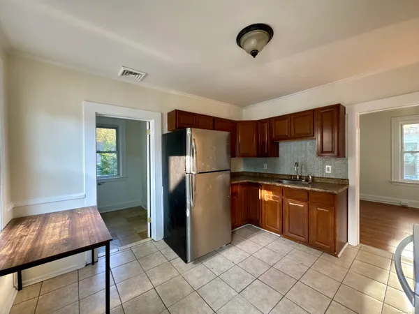 a kitchen with stainless steel appliances granite countertop a refrigerator and a stove top oven