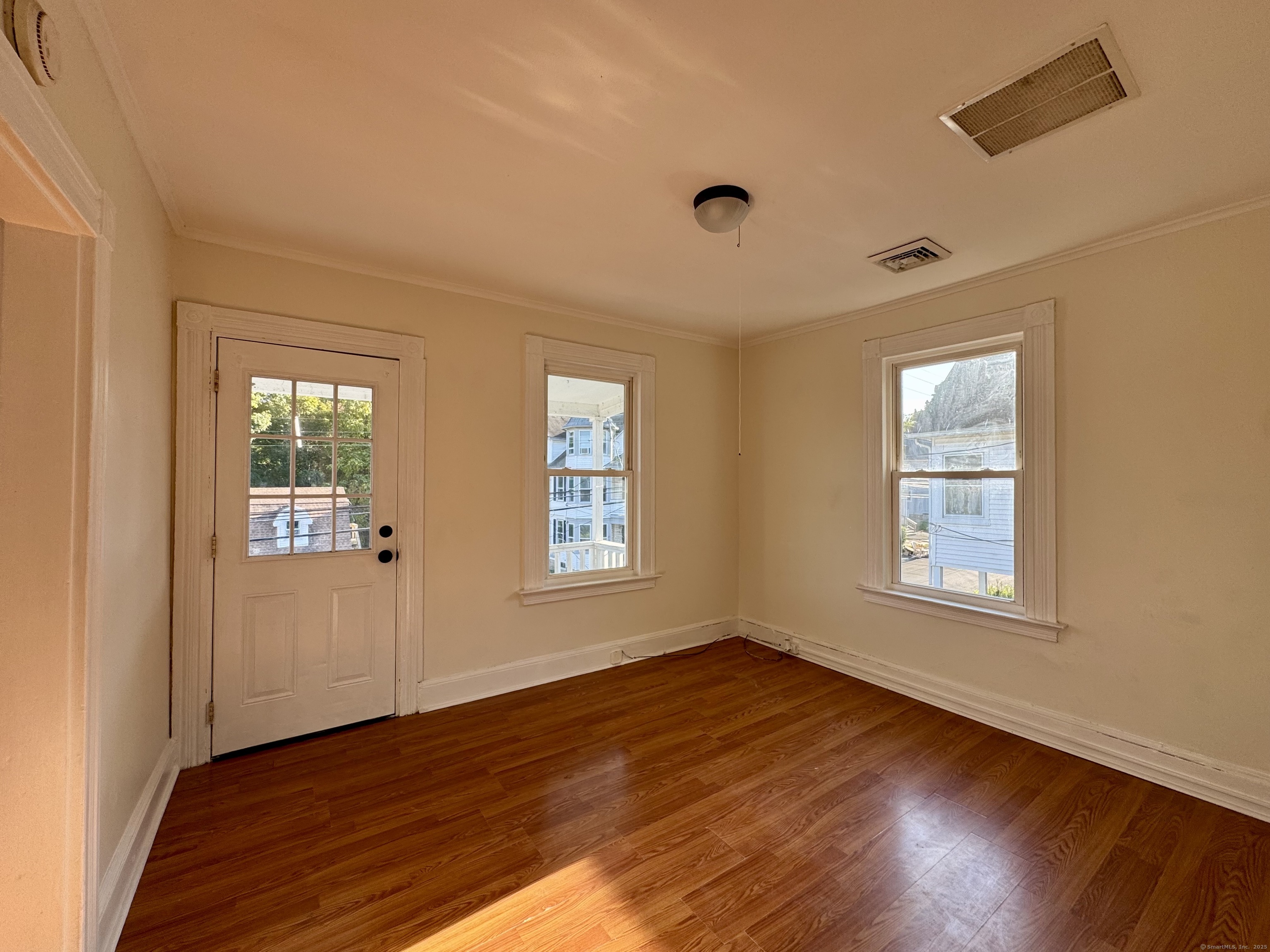 14 Culvert Street, Unit 2 Torrington, CT 06790 - Photo 4 of 17 a view of an empty room with wooden floor and a window