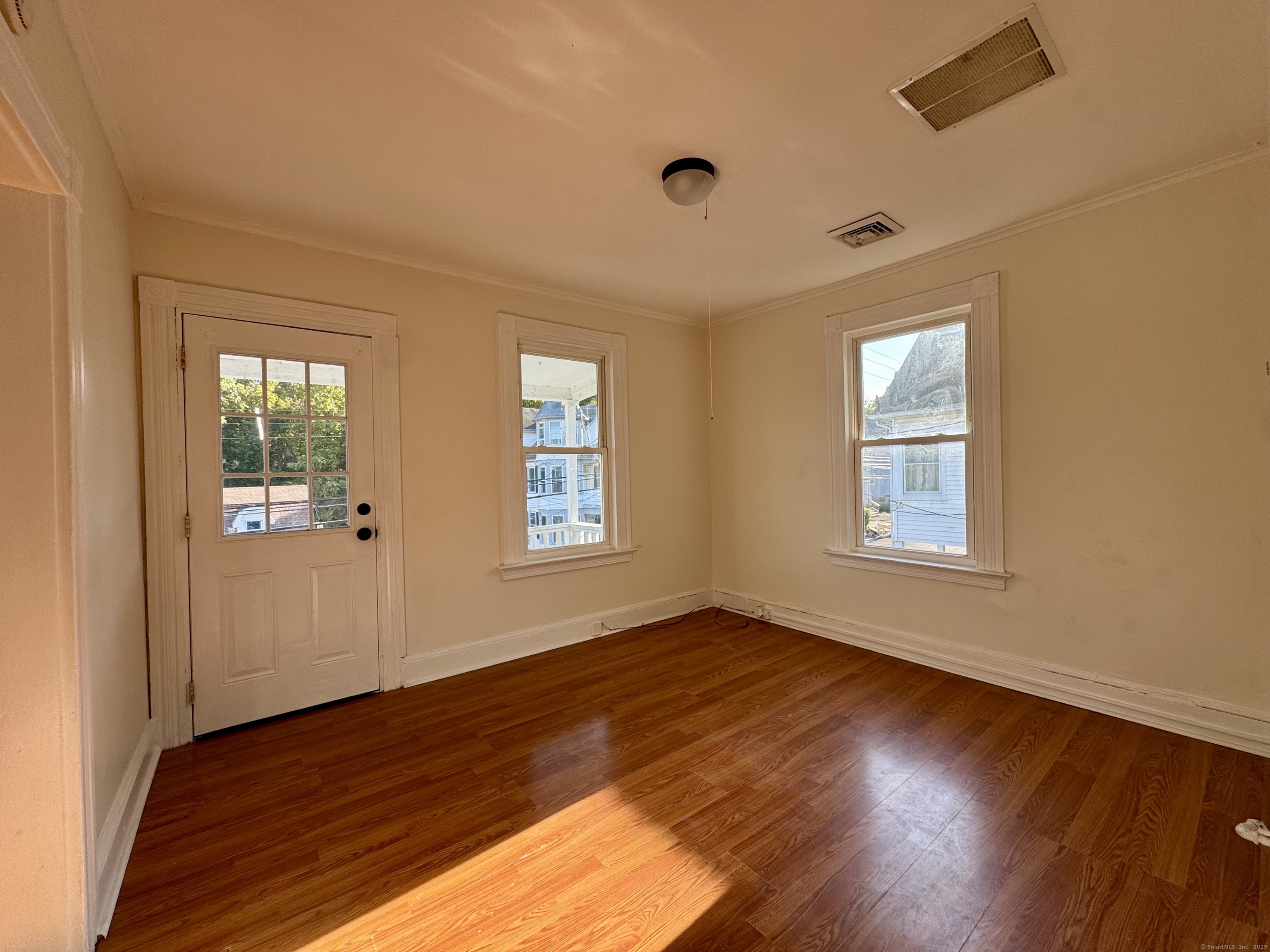 14 Culvert Street, Unit 2 Torrington, CT 06790 - Photo 9 of 17 an empty room with wooden floor and windows