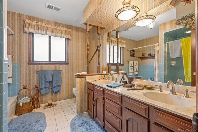 a bathroom with a double vanity sink and a mirror