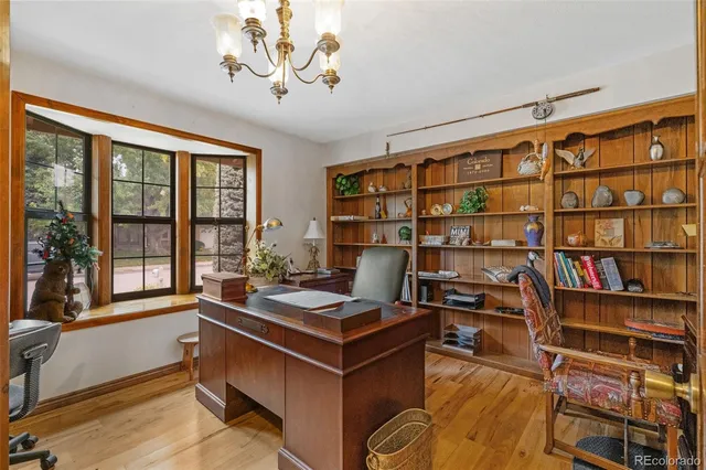 a work room with furniture and a bookshelf