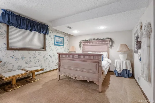 a bedroom with furniture and a window