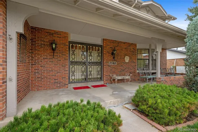 a view of a porch with a table and chairs and potted plants