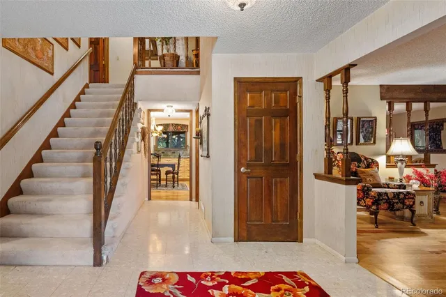 a view of a hallway with wooden floor and windows