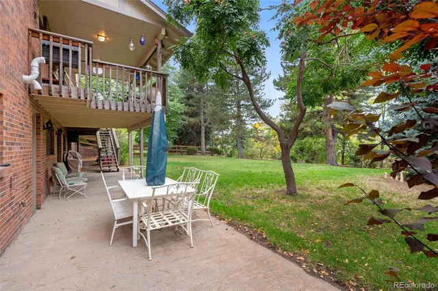 a view of a chairs and table in backyard of the house