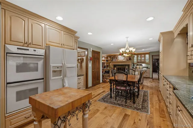 a kitchen with stainless steel appliances kitchen island granite countertop a refrigerator and microwave