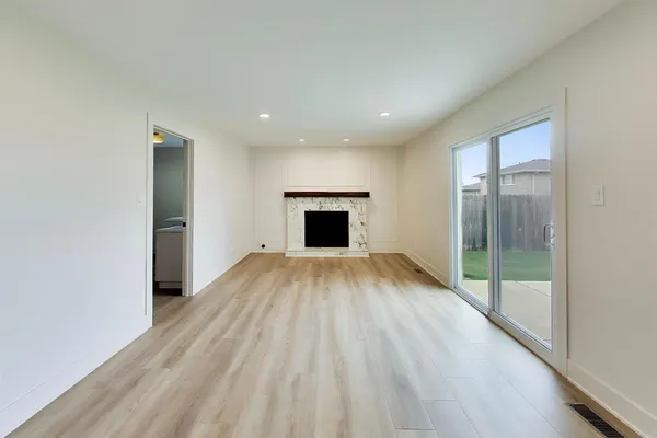 wooden floor in an empty room with a fireplace