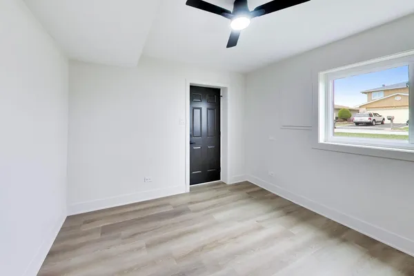 an empty room with windows and closet