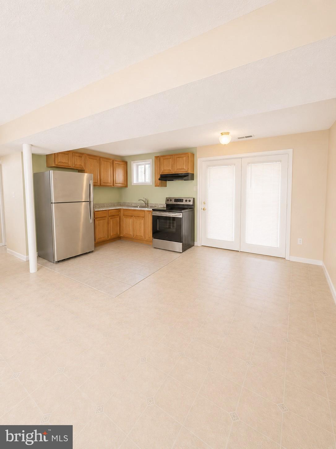 6204 Cipriano Road Lanham, MD 20706 - Photo 13 of 19 a view of kitchen and empty room with furniture