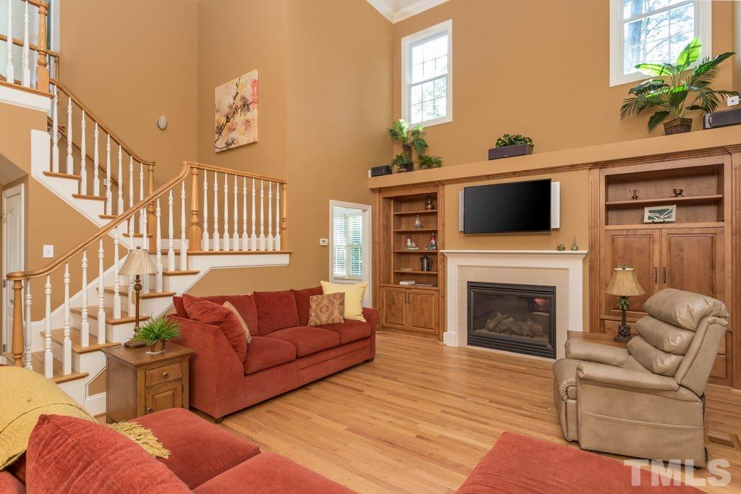 7220 Sunset Glen Point Raleigh, NC 27614 - Photo 11 of 25 The family room is bright and airy with many windows and a greatly high ceiling. Beautiful gas-log fireplace!