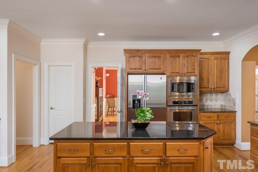 7220 Sunset Glen Point Raleigh, NC 27614 - Photo 4 of 25 Storage space abounds with many cabinets, storage all around island plus pantry!
