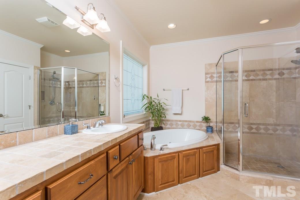 7220 Sunset Glen Point Raleigh, NC 27614 - Photo 8 of 25 The master bath has walk-in glass shower, jetted tub, dual vanity and water closet. Intricate stone tile throughout.