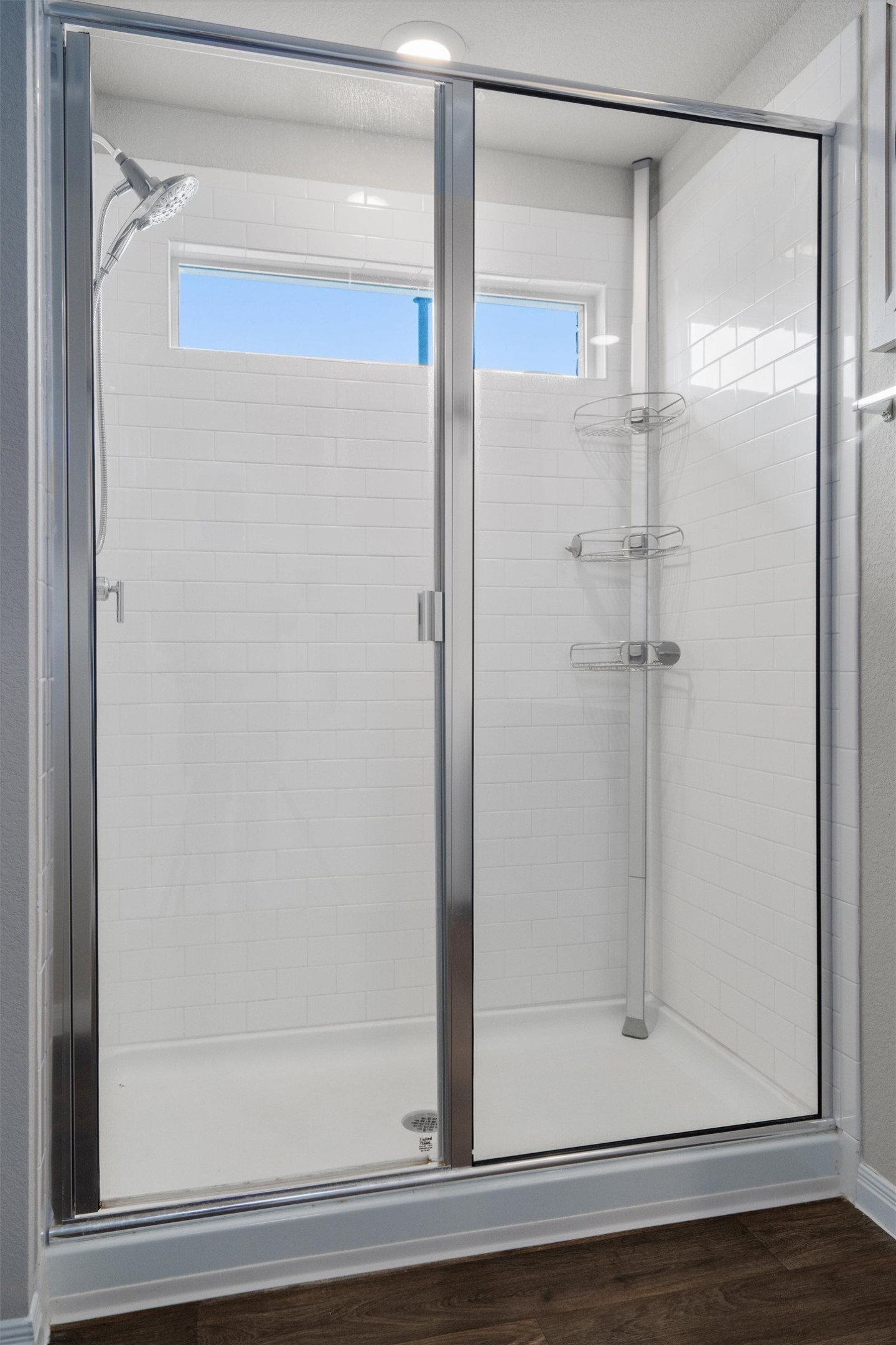 19525 Abigail Fillmore Road Manor, TX 78653 - Photo 17 of 38 Modern shower with pristine subway tile and practical glass enclosure.