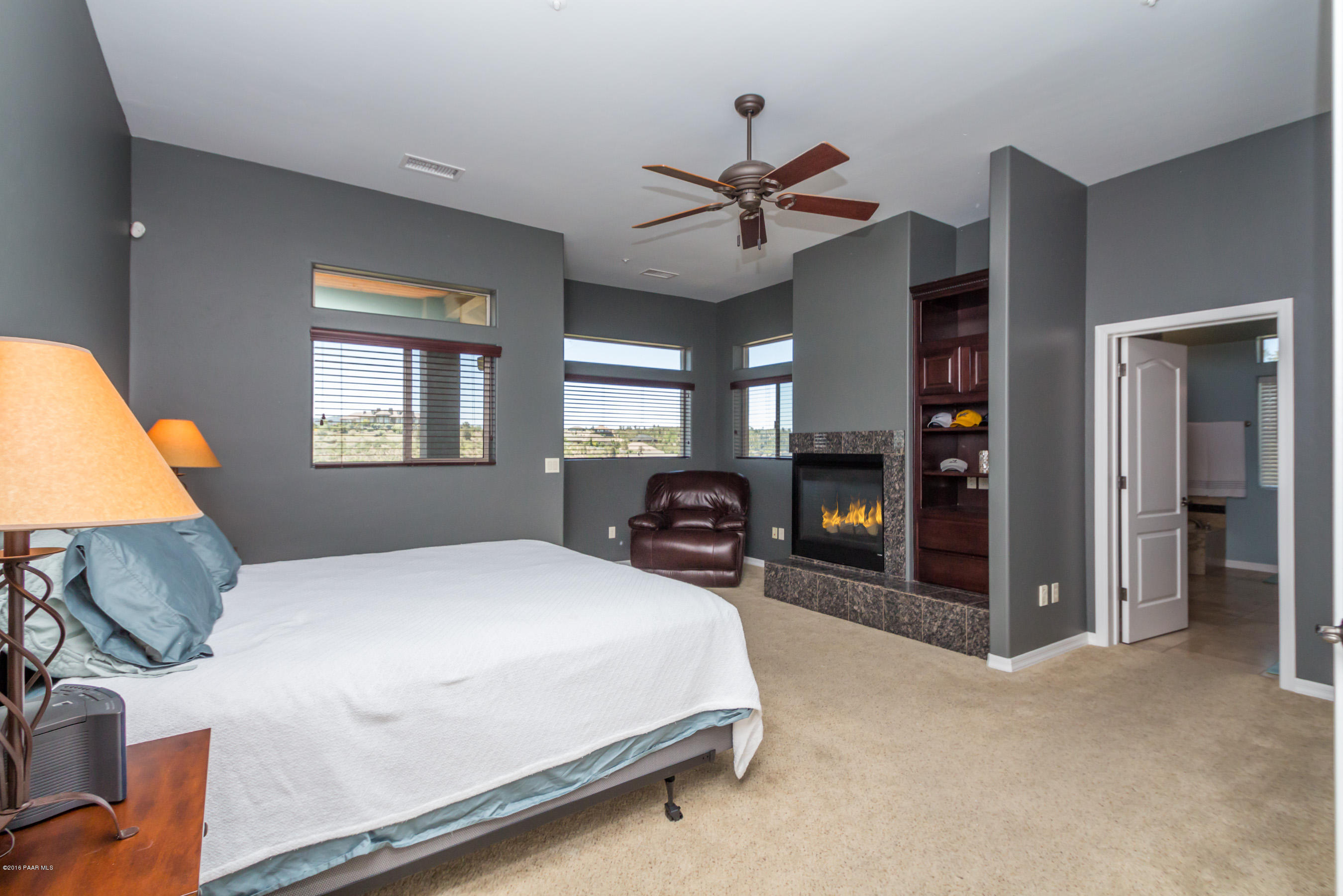 1055 Vantage Point Circle Prescott, AZ 86301 - Photo 12 of 38 a bedroom with a bed and a chandelier