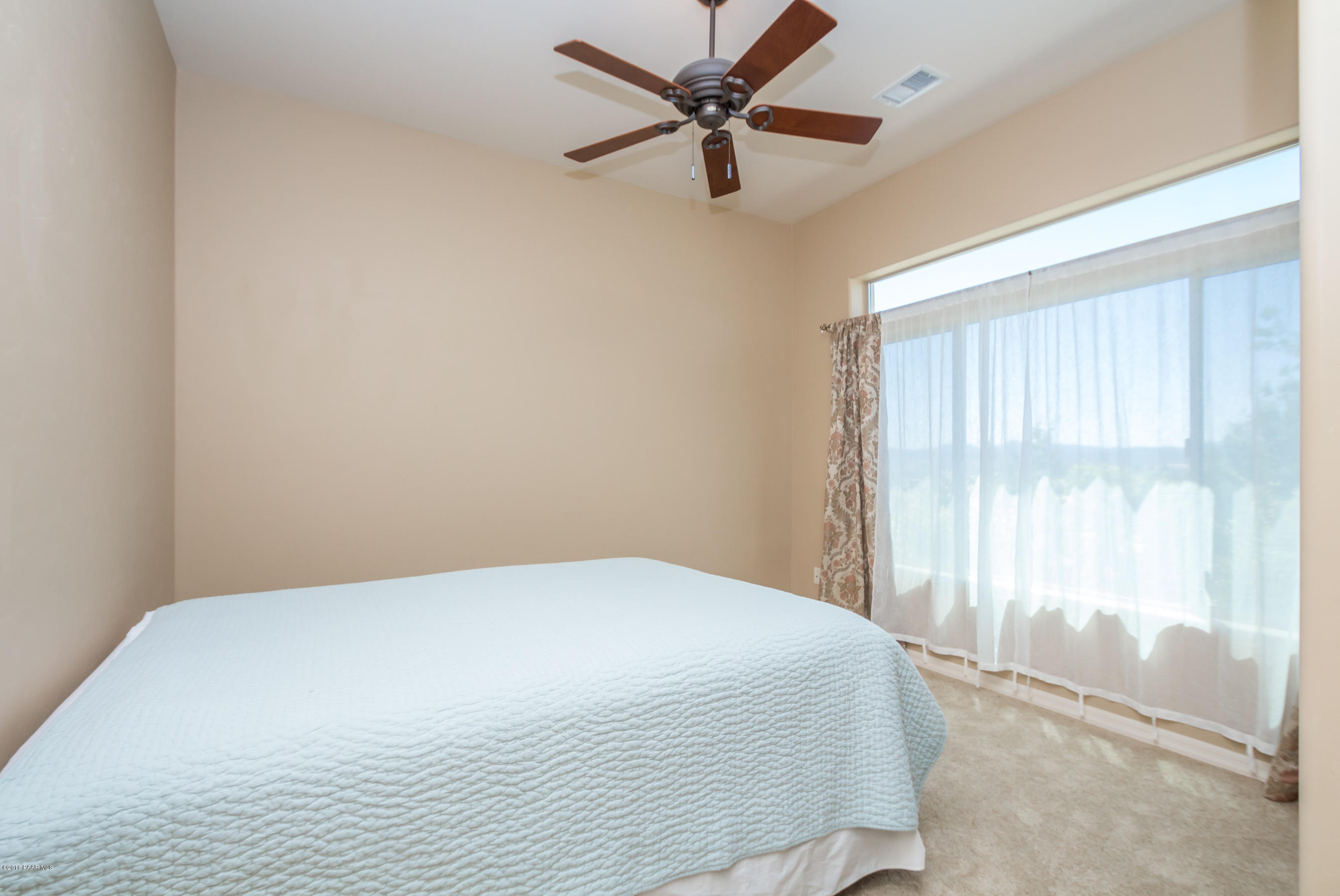 1055 Vantage Point Circle Prescott, AZ 86301 - Photo 23 of 38 a bedroom with a bed and a large window